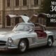 Mercedes 300SL classic sports car parked outdoors, showcasing its sleek body, iconic gullwing doors, and vintage design.